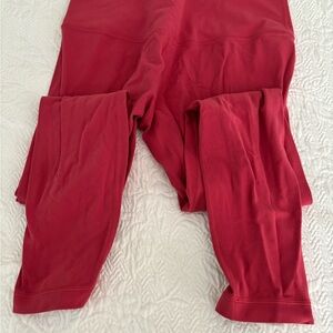 Pink/Strawberry Lululemon leggings. Probably a medium size.